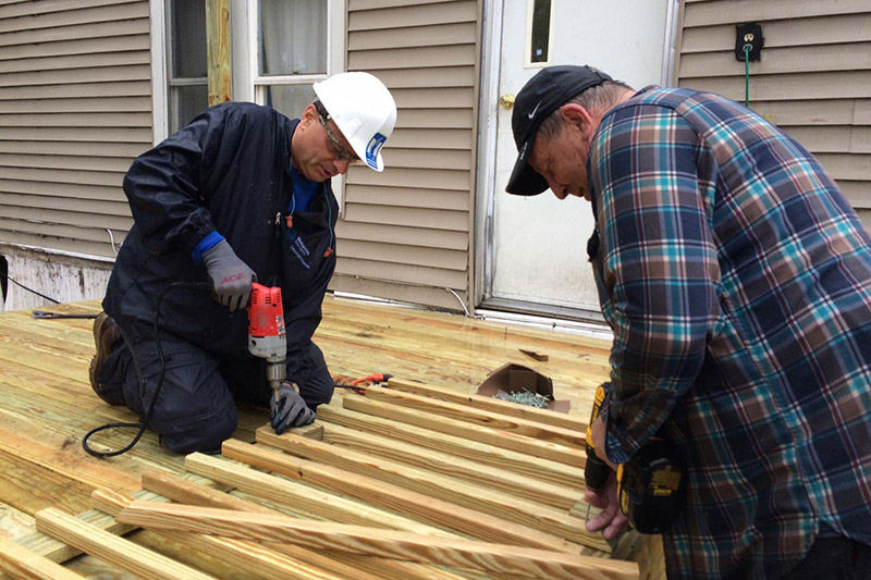 Two men building porch